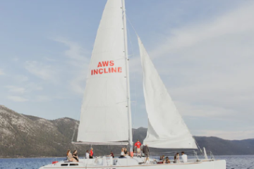 Sailing catamaran with 'Sierra Cloud' on hull, mountains in background.